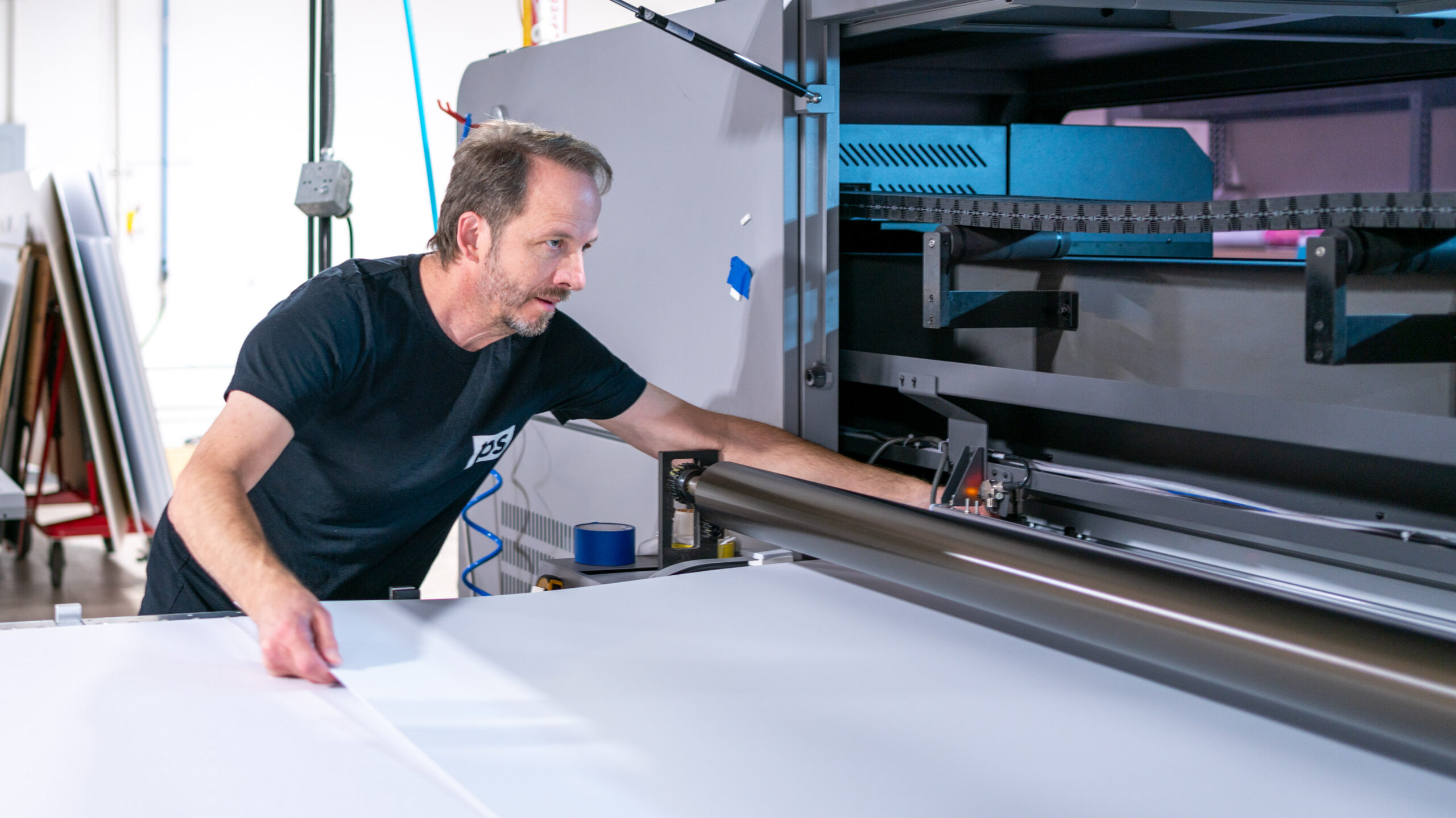Employee working a wide format press