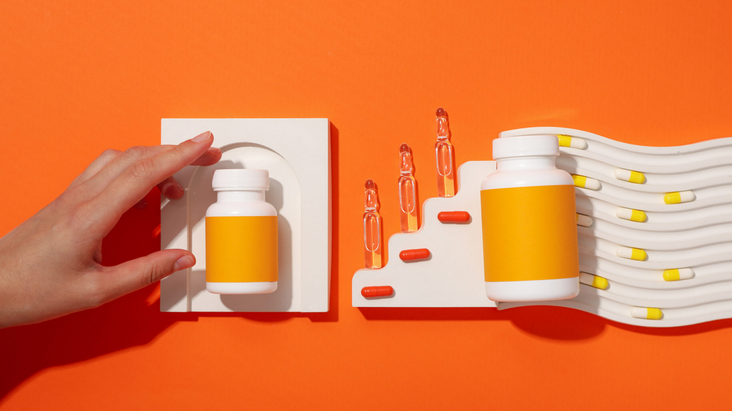 Vitamin c biosupplement in ampoules on orange background